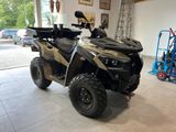 an image of a black and tan atv in a garage
