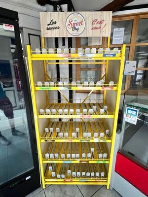 a display case with several bottles of soda in it
