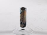 a small glass vase sitting on top of a glass stand