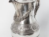 an antique silver plated coffee pot with a handle and handles