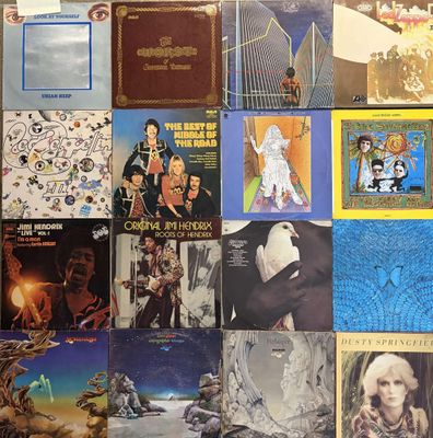 many different album covers on the wall of this room
