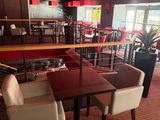 tables and chairs in a restaurant with red walls and a red ceiling