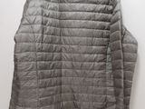 a close up of a jacket on a hanger on a wall