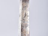 a close up of a sword with a gold handle