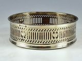 an antique silver plate with a design on the rim