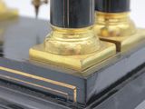 a black and gold clock on a black table