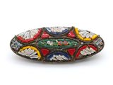 a close up of a brooch with a fish design on it