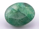a close up of a green stone on a white surface