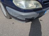 a blue car that is parked on the side of the road