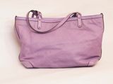 purple handbag on a white surface with a white background
