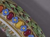 a close up of a decorative mirror with flowers on it
