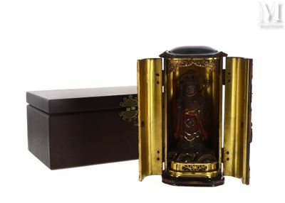 a small wooden box with a statue inside of it