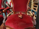 two red chairs sitting next to each other on a wooden floor
