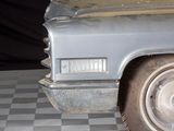 a old car that is sitting on a checkered floor