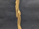 an image of a statue of a man standing on a wooden base