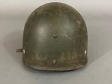 an old army helmet on a table with a white background