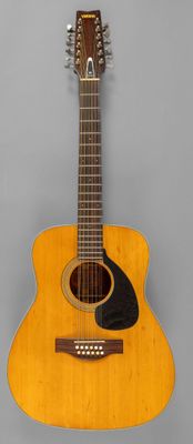 an image of a guitar hanging on a wall in a room