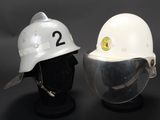 pair of white helmets with numbers 2 and 2 on them on a mannequin head