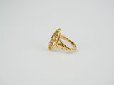 a gold ring with an oval stone surrounded by small diamonds