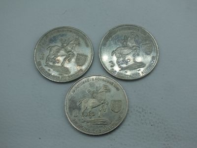 trois pièces d'argent empilées les unes sur les autres sur une table