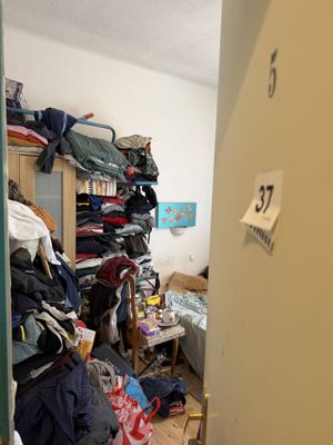 a closet full of clothes in a small room