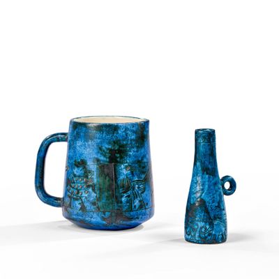 two blue vases sitting next to each other on a white surface