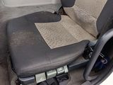 a seat in the back of a car that is dirty