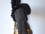 a stuffed animal that is sitting in a gold vase