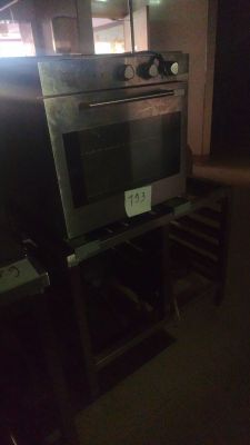 an oven that is sitting on a stand in the dark