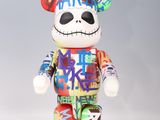 a multicolored teddy bear that is standing on a white surface