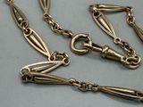 a gold chain that has a long link on it