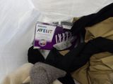 a teddy bear and a box of baby food on a bed