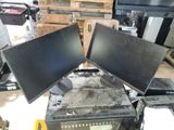 two computer monitors sitting on top of each other