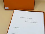 an orange box with a white cover and a black and white picture of a clock