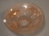 a glass bowl with a hole in it on a table