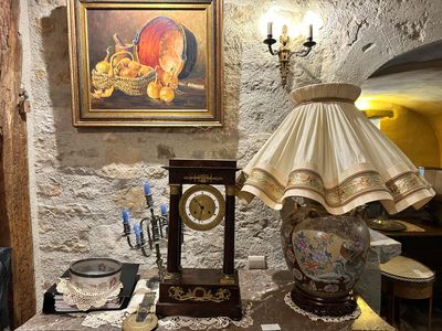 a table with a lamp and a clock on it