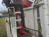 a dump truck that is sitting in the grass