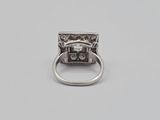 a close up of a silver ring with a diamond on it