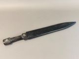 a knife that is laying on a white surface