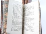 a person holding an open book in their hand