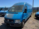 many blue vans parked in a parking lot