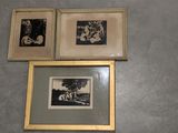 three framed pictures on the wall of a bathroom