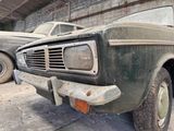 an old truck that is parked in a garage