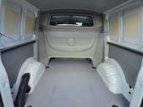 a white van with its doors open in a parking lot