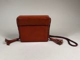 an image of a small brown purse with tassels on it