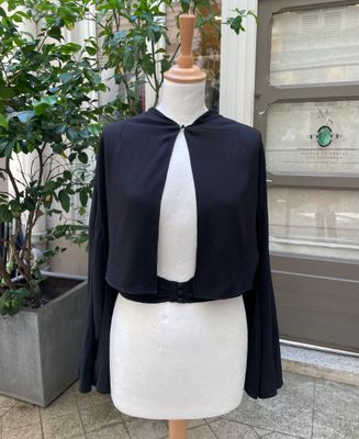 a mannequin dress on a mannequin stand in front of a building