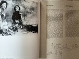 someone is holding a book open to a drawing of a man and a woman