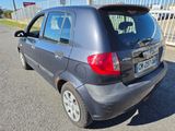 a small grey car parked in a parking lot
