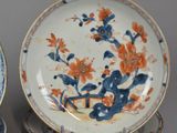 pair of blue and white plates with orange flowers on them