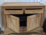 a wooden cabinet with two doors open on a hard wood floor